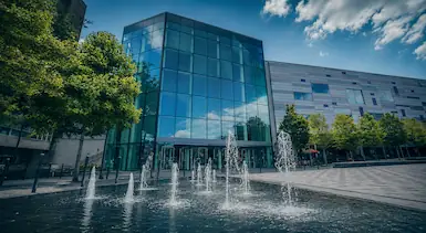 Modern Luton town centre building with fountains and public square, representing TradeHub Platform helping Luton trade businesses improve websites, local SEO and online customer visibility.