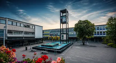 Stevenage town centre square with clock tower and modern civic buildings, representing TradeHub Platform helping Stevenage tradespeople improve websites, SEO and local online visibility.