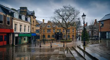 Wellingborough town centre street with traditional brick buildings and local shops, representing TradeHub Platform supporting trade businesses with websites, local SEO and online visibility growth.