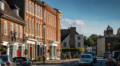 Woburn village street with traditional brick buildings and historic shopfronts, representing TradeHub Platform helping Woburn trade businesses build trust online through websites, SEO and digital growth systems.